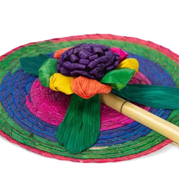 Ethnic and colorful hand fan made with palm tree leaves